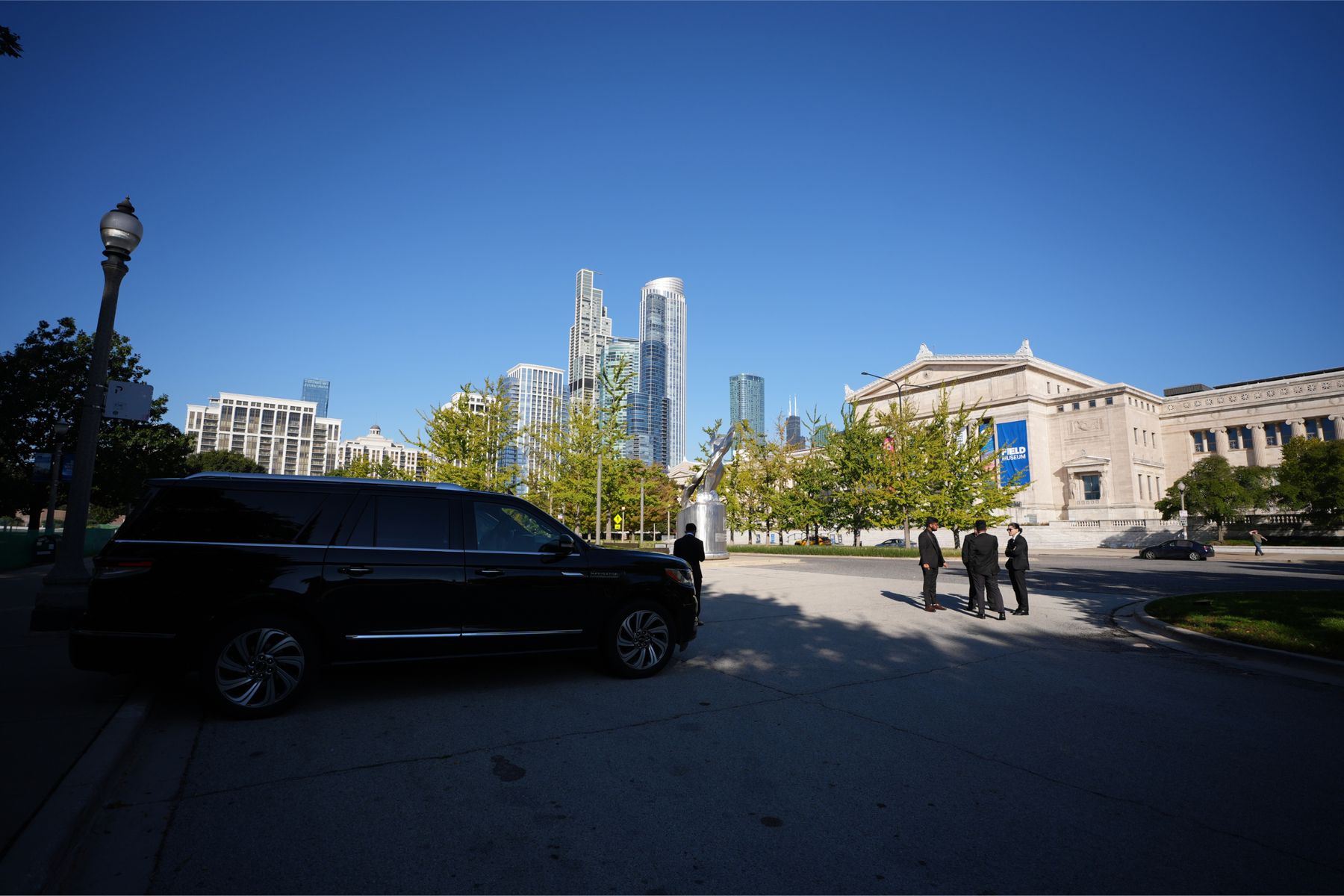 Black luxury SUV with the Chicago skyline behind